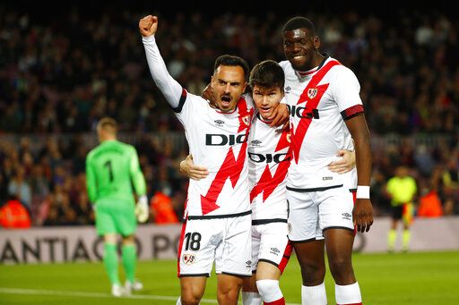 ep-304249918-6 Rayo's team players celebrate after Alvaro Garcia, left, scored the opening goal during a Spanish La Liga soccer match between FC Barcelona and Rayo Vallecano at the Camp Nou stadium in Barcelona, Spain, Sunday, April 24, 2022.
